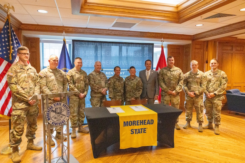 The recruiting and retention team of Kentucky National Guard poses for a photo with U.S. Army Maj. Gen. Haldane Lamberton, Kentucky’s adjutant general, and Dr. Jay Morgan, president of Morehead State University (MSU) after the signing of the memorandum of understanding (MOU) between MSU and KYNG at MSU in Morehead, Ky. on May 5, 2025. KYNG and MSU signed the MOU to give more educational benefits to Soldiers and Airmen of the KYNG. (U.S. Army National Guard photo by Andy Dickson)