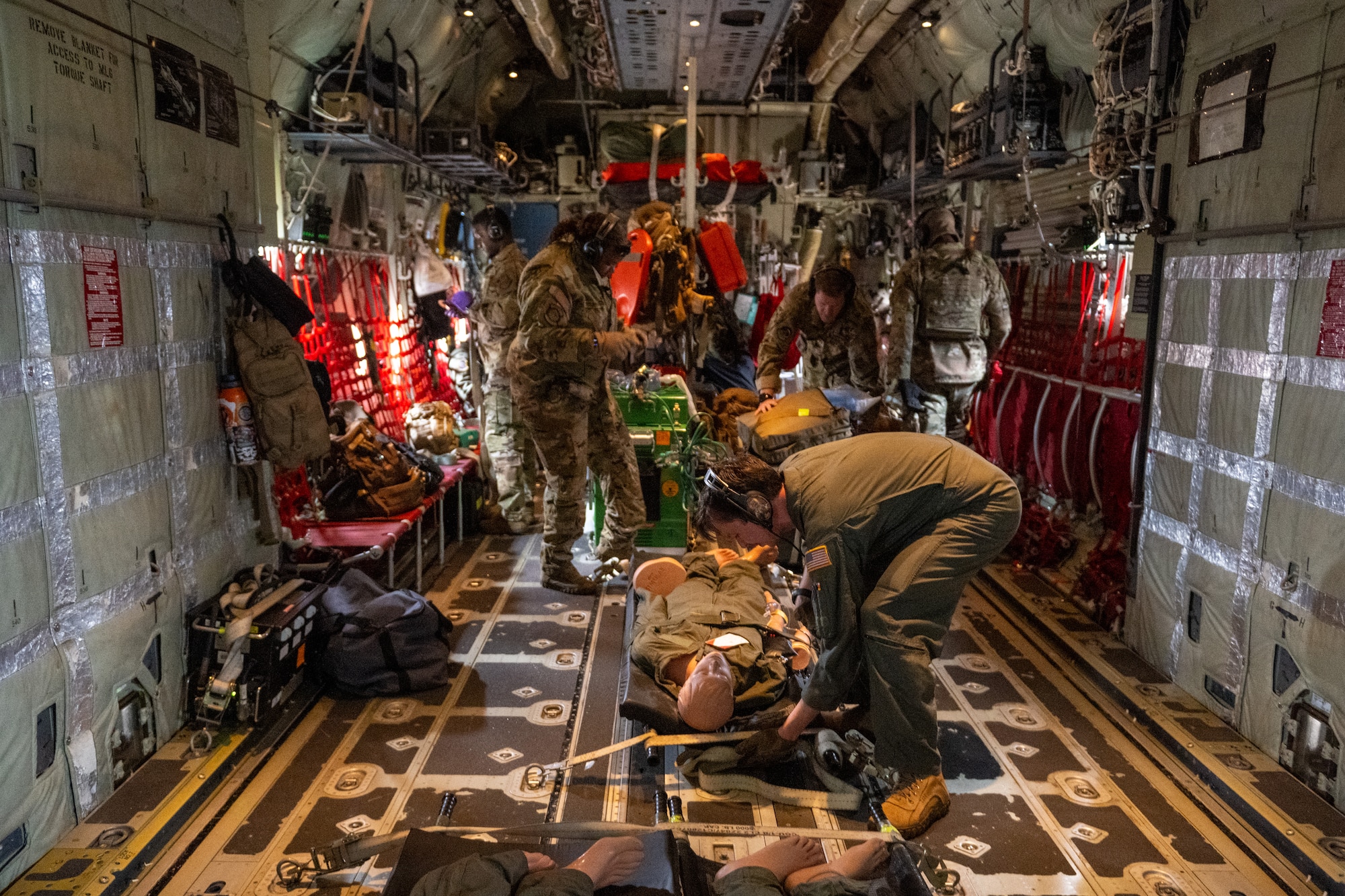 U.S. Air Force Airmen assigned to the 908th Aero-Medical Evacuation Squadron and 71st Rescue Squadron execute an aero-medical evacuation training at Maxwell Air Force Base, Alabama, May 1, 2025. During the one hour flight crew practiced different skills such as inserting IVs and administering blood products in flight. (U.S. Air Force photo by Airman 1st Class Iain Stanley)