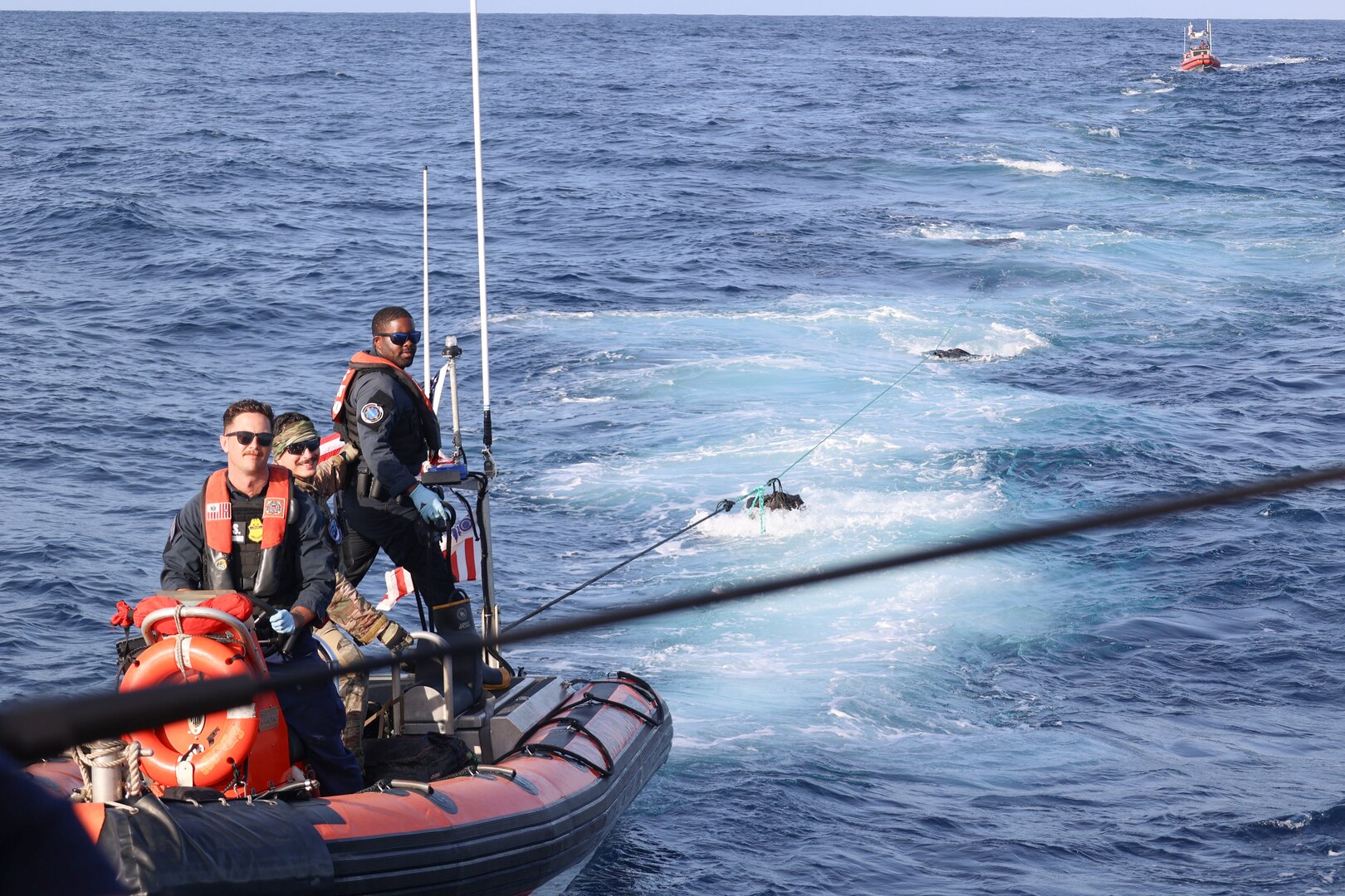 Coast Guard Cutter Forward (WMEC 911) small boat crews work together to tow 37 jettisoned bales of cocaine, worth more than $23 million, to the cutter after interdicting a drug smuggling vessel in the Eastern Pacific Ocean, March 21, 2025. Forward’s crew conducted a 79-day counter-drug patrol in the Eastern Pacific Ocean. (U.S. Coast Guard photo by Petty Officer 3rd Class Carter Bossard)