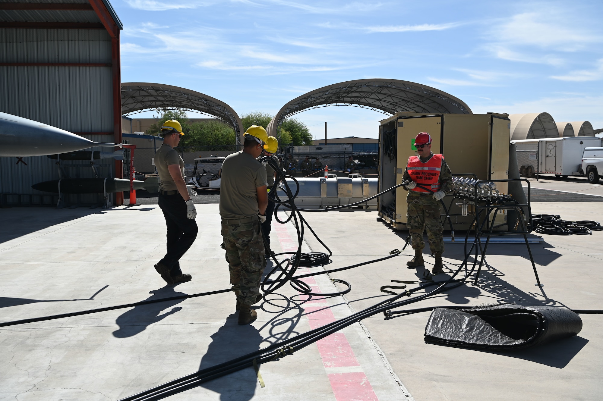U.S. guardsmen assigned to the 162nd Wing Crashed, Damaged, and Disabled Aircraft Recovery team begin simulated aircraft recovery procedures during a Mass Accident Recovery Exercise at Morris Air National Guard Base, Ariz., May 14, 2025. The CDDAR team is responsible for responding and recovering aircraft that have become disabled or damaged, whether on the runway, after a crash, or due to landing gear issues.(U.S. Air National Guard photo by Maj. Lacey Perry)