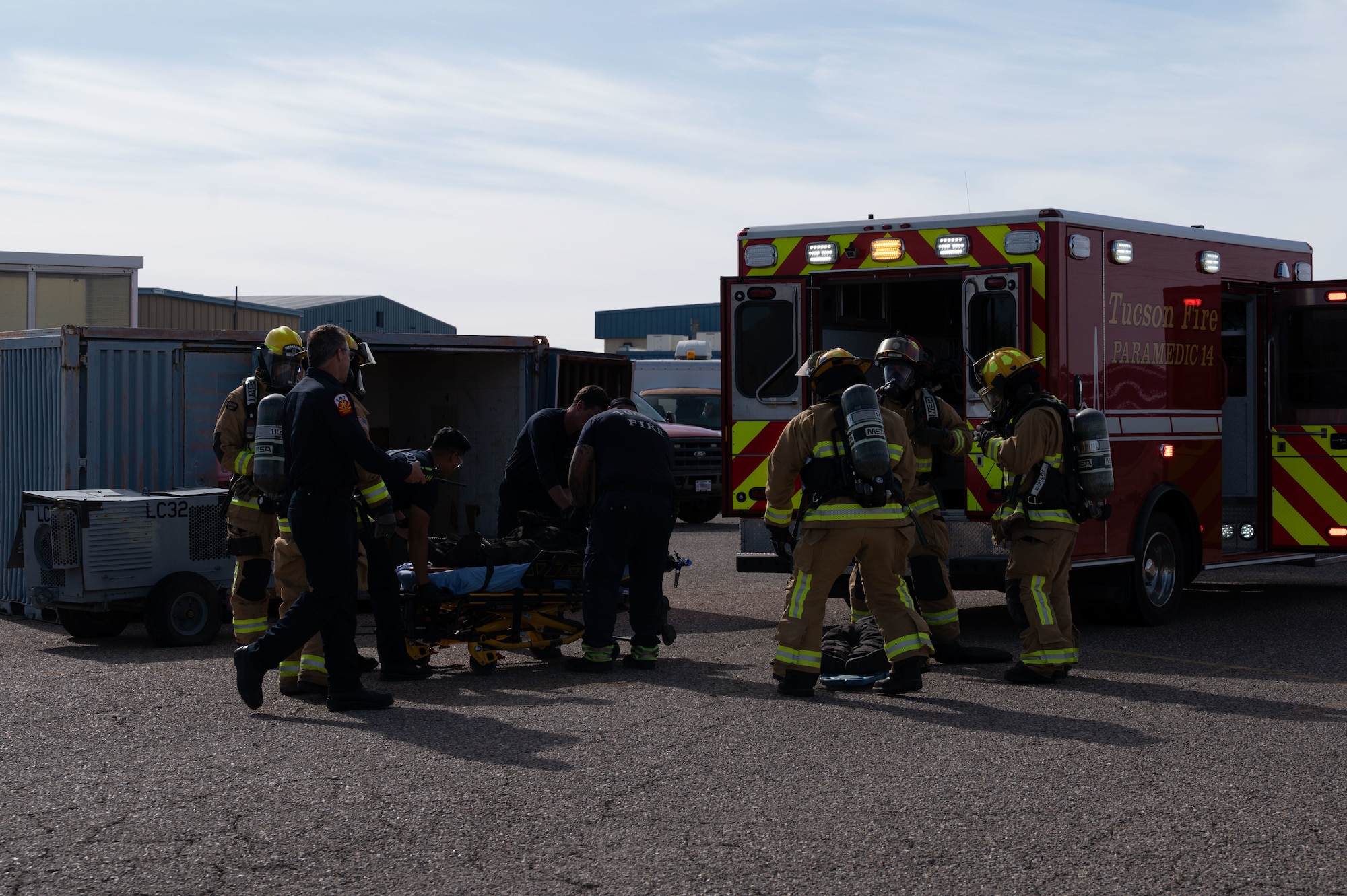 Emergency responders transport a simulated casualty into an ambulance during a Mass Accident Response Exercise at Morris Air National Guard Base, Ariz., May 14, 2025. The 162nd Wing facilitates real-world joint training exercises, such as a MARE to prepare Airmen for the challenges of aircraft accident response. (U.S. Air National Guard photo by Staff Sgt. Guadalupe Beltran)