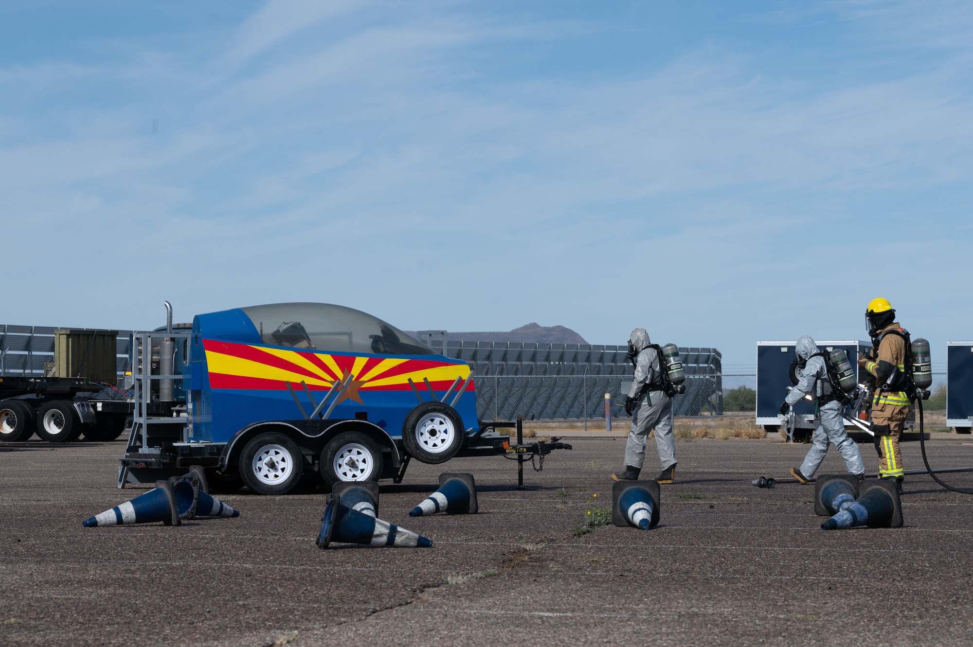 Emergency Management personnel approach a simulated damaged aircraft during a Mass Accident Response Exercise at Morris Air National Guard Base, Ariz., May 14, 2025. The 162nd Wing hosts real-world joint training exercises to hone tactical skills that ensure the safety of both first responders and simulated victims. (U.S. Air National Guard photo by Staff Sgt. Guadalupe Beltran)