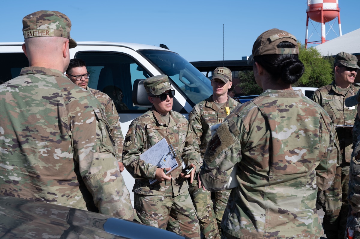 U.S. Air National Guard Tech. Sgt. Amanda Stevens, 162nd Wing Inspector Team lead, briefs volunteers before a simulated Active Shooter exercise at Morris Air National Guard Base, Ariz., May 15, 2025. the 162nd Wing conducts real-world exercises to ensure all personnel know how to respond in an emergency. (U.S. Air National Guard photo by Staff Sgt. Guadalupe Beltran)