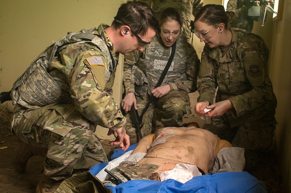 hands-on treatment...Land, sea and air assets of the U.S. military assigned in the Pacific Northwest came together to hone life-saving techniques and strategies during a joint scenario-based field Tactical Combat Casualty Care exercise, May 15, 2024 (Official Navy photo by Mass Communication Specialist 2nd Class Jennifer Benedict, NHB/NMRTC Bremerton Public Affairs).