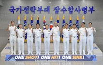 Rear Adm. Kang Dong-goo, commander, Republic of Korea (ROK) Navy Submarine Force, Rear Adm. Lincoln Reifsteck, commander, Submarine Group (CSG) 7, and their staff pose for a picture at Jeju Island, May 16, 2025, for the 60th Submarine Warfare Committee Meeting (SWCM).