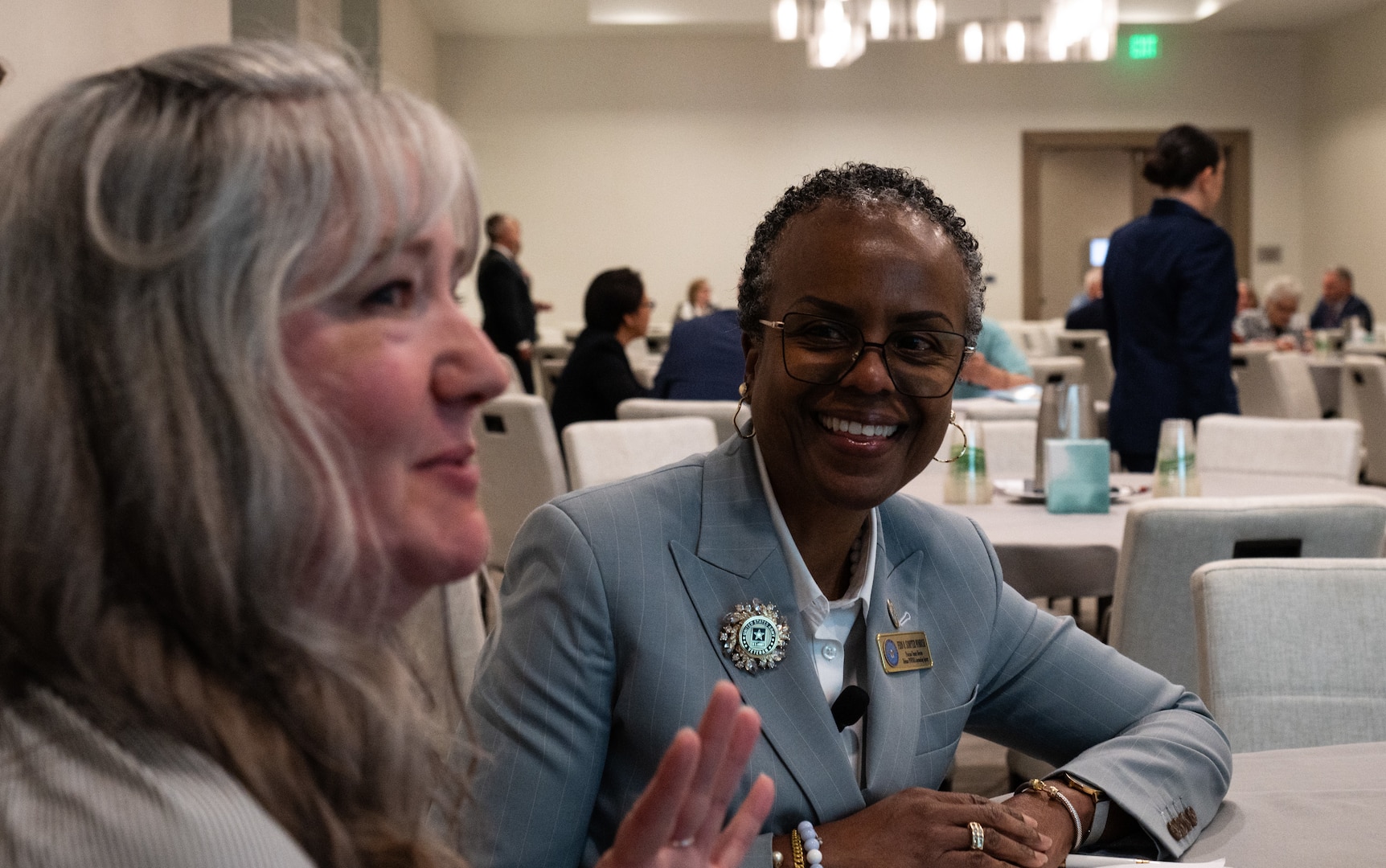 Jennifer McDaniel, family member of a missing in action service member, shares a story about her great uncle with Fern Sumpter Winbush, principal deputy director of the Defense POW/MIA Accounting Agency, during a Family Member Update in Bellevue, Washington, May 3, 2025.