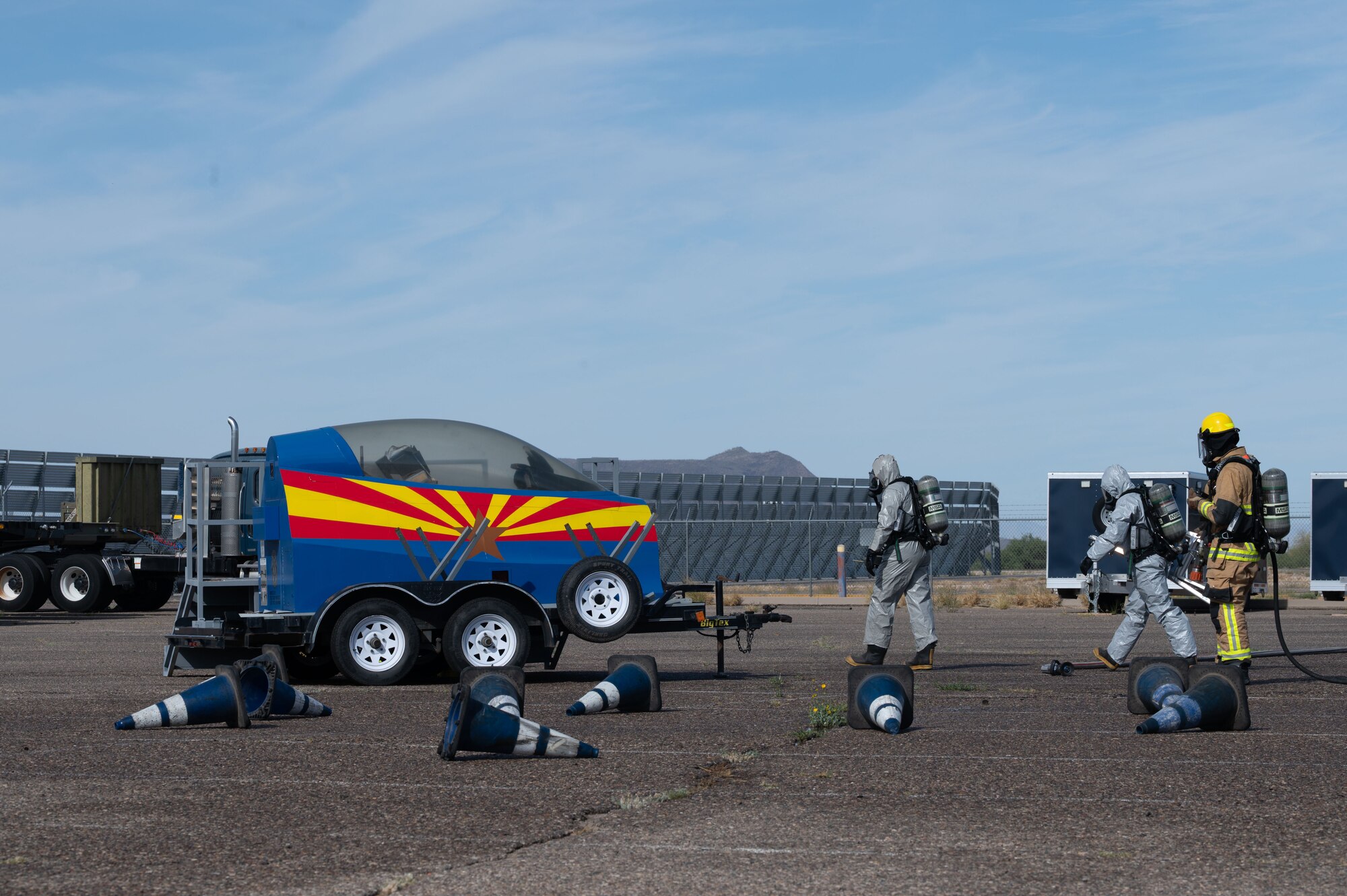 Emergency Management personnel approach a simulated damaged aircraft during a Mass Accident Response Exercise at Morris Air National Guard Base, Ariz., May 14, 2025. The 162nd Wing hosts real-world joint training exercises to hone tactical skills that ensure the safety of both first responders and simulated victims. (U.S. Air National Guard photo by Staff Sgt. Guadalupe Beltran)