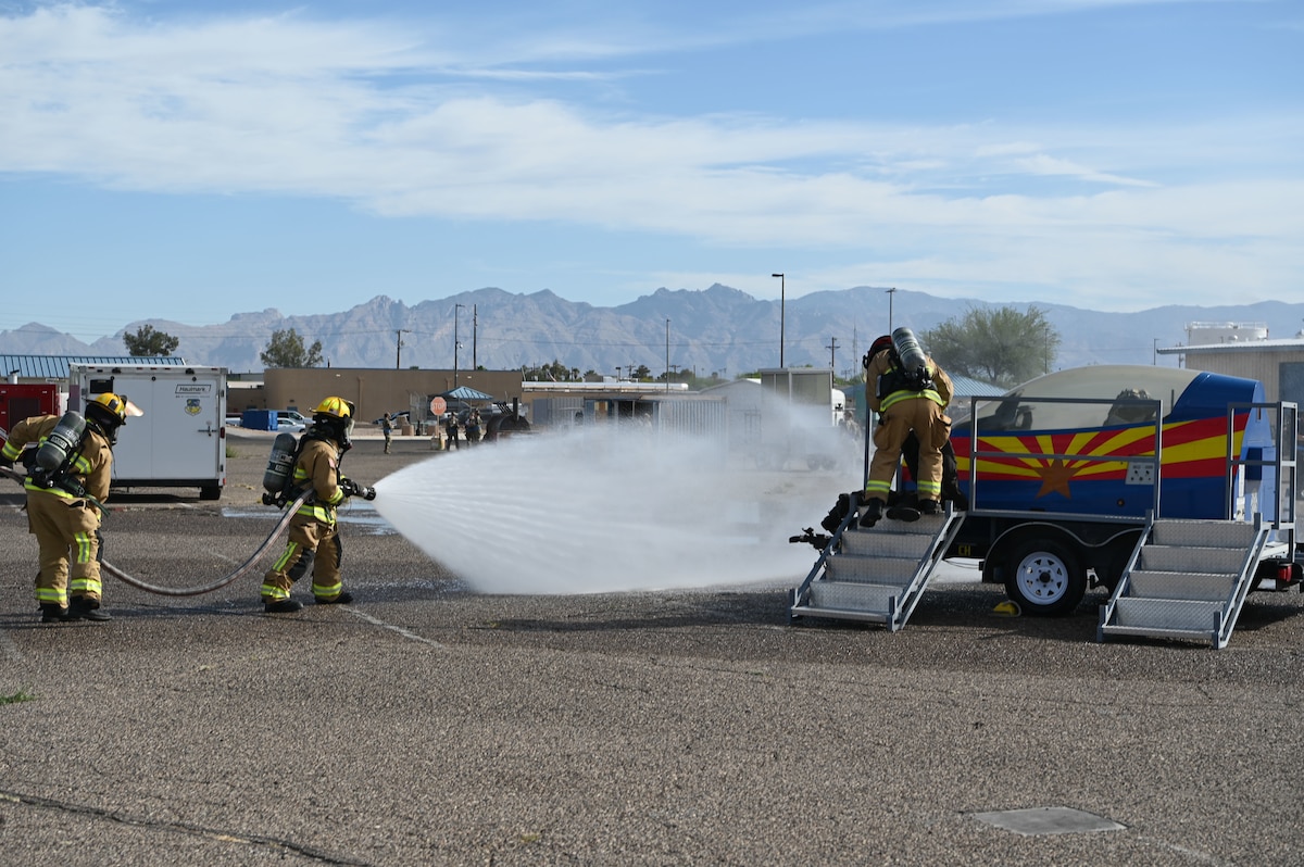 Firefighters extinguish a simulated aircraft fire during a Mass Accident Response Exercise at Morris Air National Guard Base, Ariz., May 14, 2025. Simulated MAREs help the 162nd Wing respond to real-world emergencies. (U.S. Air National Guard photo by Maj. Lacey Perry)