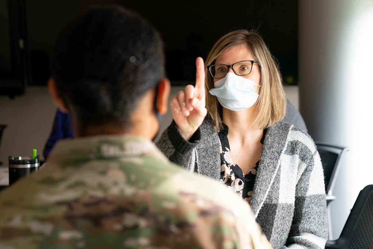 Image of a civilian treating a Soldier.