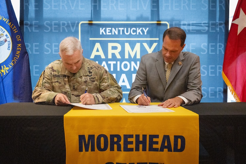 U.S. Army Maj. Gen. Haldane Lamberton (left), Kentucky’s adjutant general, and Dr. Jay Morgan, president of Morehead State University (MSU) signs the memorandum of understanding (MOU) between MSU and KYNG at MSU in Morehead, Ky. on May 5, 2025. KYNG and MSU signed the MOU to give more educational benefits to Soldiers and Airmen of the KYNG. (U.S. Army National Guard photo by Andy Dickson)