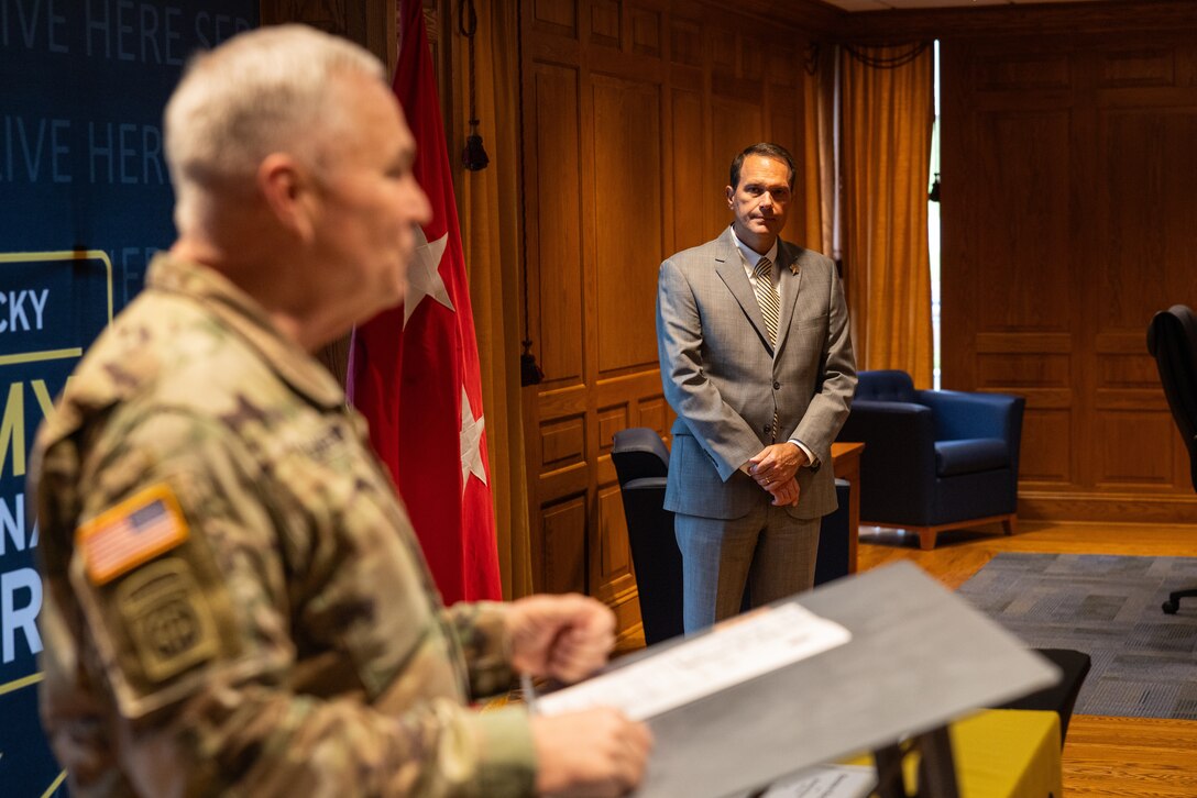 Dr. Jay Morgan, president of Morehead State University (MSU), listens to U.S. Army Maj. Gen. Haldane Lamberton, Kentucky’s adjutant general, speak to the crowd of Kentucky National Guard (KYNG) leaders, recruiters, and MSU faculty and staff during the ceremony of the signing of a memorandum of understanding (MOU) between MSU and KYNG at Morehead State University in Morehead, Ky. on May 5, 2025. KYNG and MSU signed the MOU to give more educational benefits to Soldiers and Airmen of the KYNG. (U.S. Army National Guard photo by Andy Dickson)