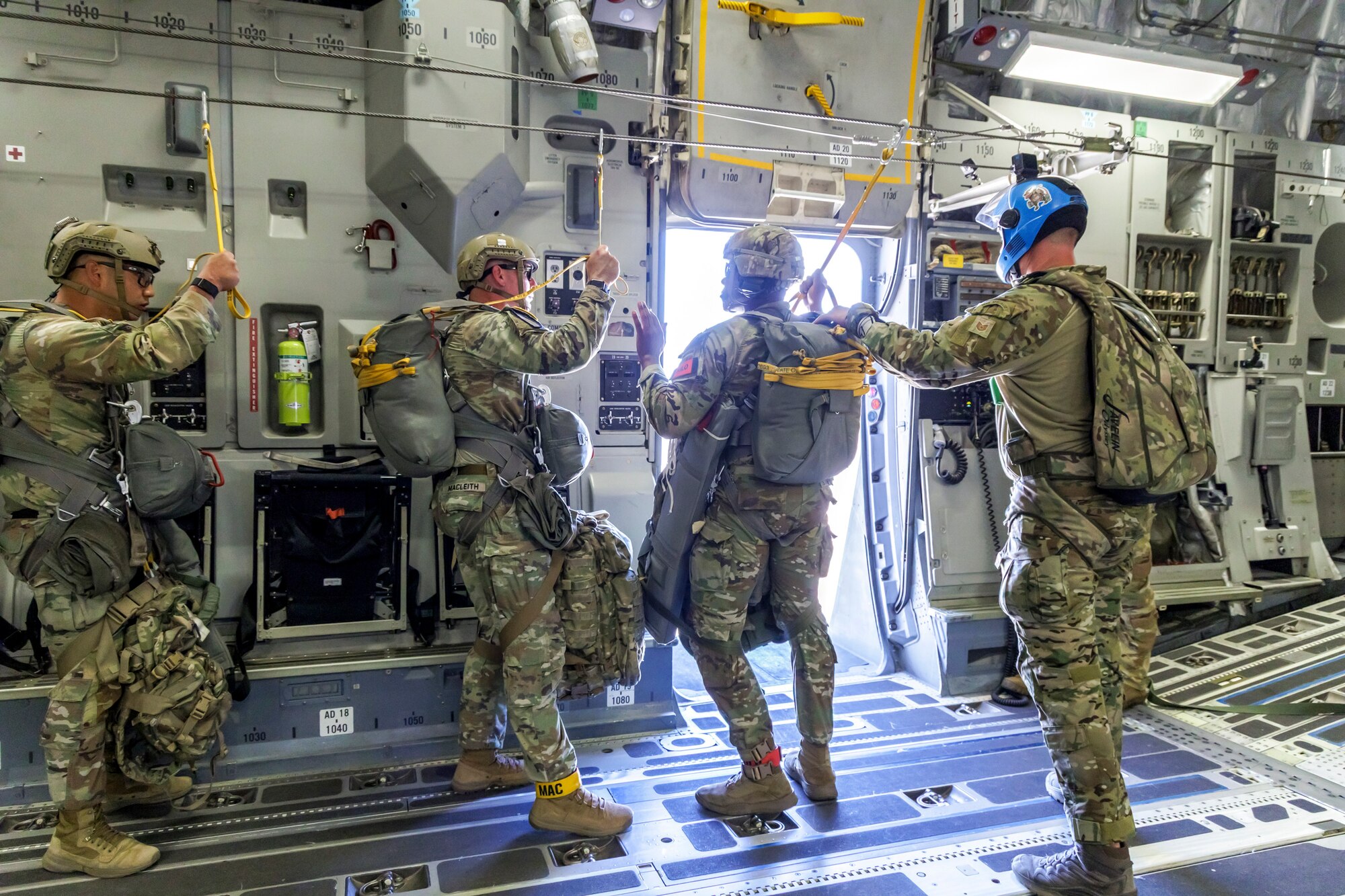 Tech. Sgt. Robert Gregory, 412th OSS SERE/TPP superintendent, prepares Army Civil Affairs troopers for a static line jump aboard a C-17 above Edwards Air Force Base, California, April 11. (Air Force photo by James West)