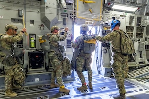 Tech. Sgt. Robert Gregory, 412th OSS SERE/TPP superintendent, prepares Army Civil Affairs troopers for a static line jump aboard a C-17 above Edwards Air Force Base, California, April 11. (Air Force photo by James West)