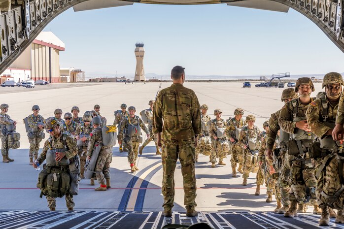 Tech. Sgt. Tanner Sullivan, 418th Flight Test Squadron C-17 loadmaster, looks onward as Army Civil Affairs paratroopers board a C-17 at Edwards Air Force Base, California, April 11. (Air Force photo by James West)