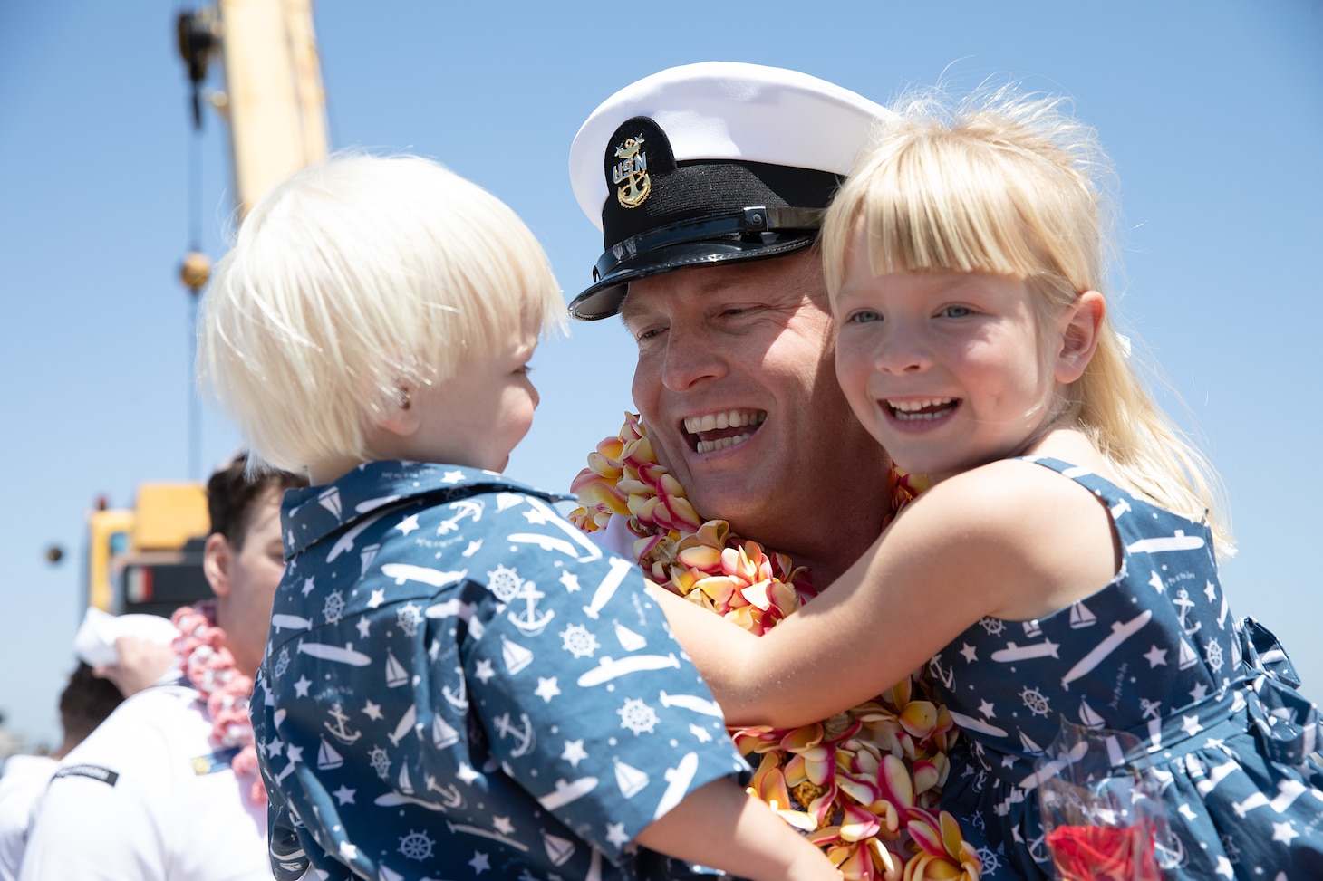 Master Chief Machinist's Mate (Auxiliary) Mitchell Gatton, Los Angeles-class fast-attack submarine USS Alexandria’s (SSN 757) chief of the boat, embraces his children as Alexandria returns to Naval Base Point Loma following a seven-month deployment to the U.S. Indo-Pacific Command area of responsibility, May 15, 2025.