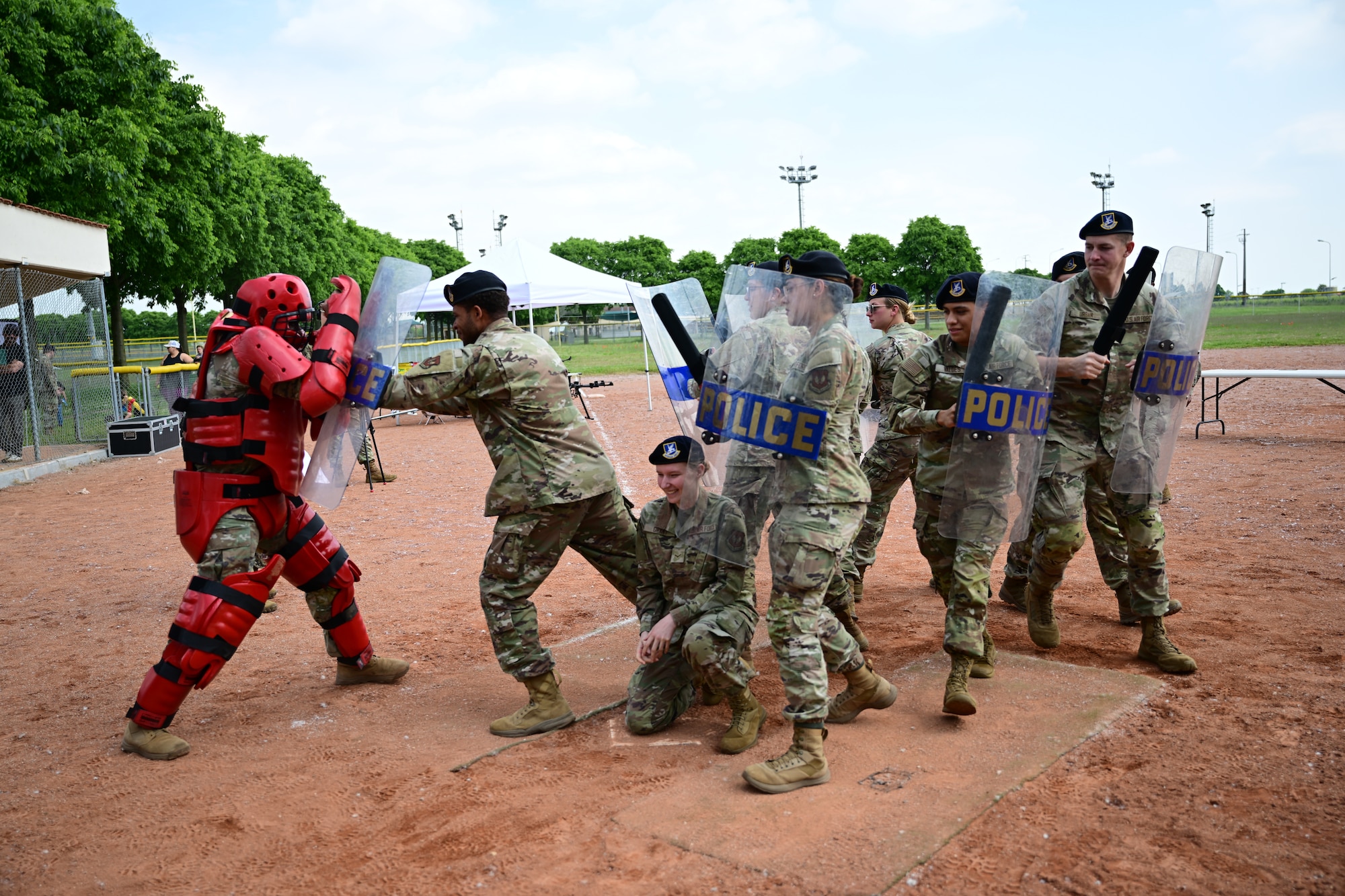 Military police officers practice riot control.