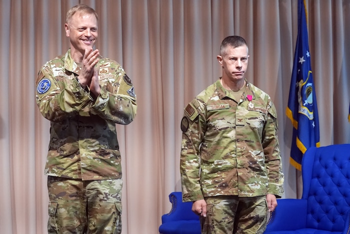 HANSCOM, AIR FORCE BASE, Mass., (May 6, 2025) – Maj. Gen. Luke Cropsey, left, awards Col. Louis Duncan with The Legion of Merit during a ceremony at the Hanscom Minuteman Commons, here, May 6, 2025. Duncan received the award for his achievements while serving as the Airspace Mission Planning Division’s senior materiel leader, a position he relinquished during the ceremony. The division is part of the Department of the Air Force’s Program Executive Office for Command, Control, Communications and Battle Management. Cropsey is C3BM’s program executive officer. (Official Air Force Photo by Richard Blumenstein).