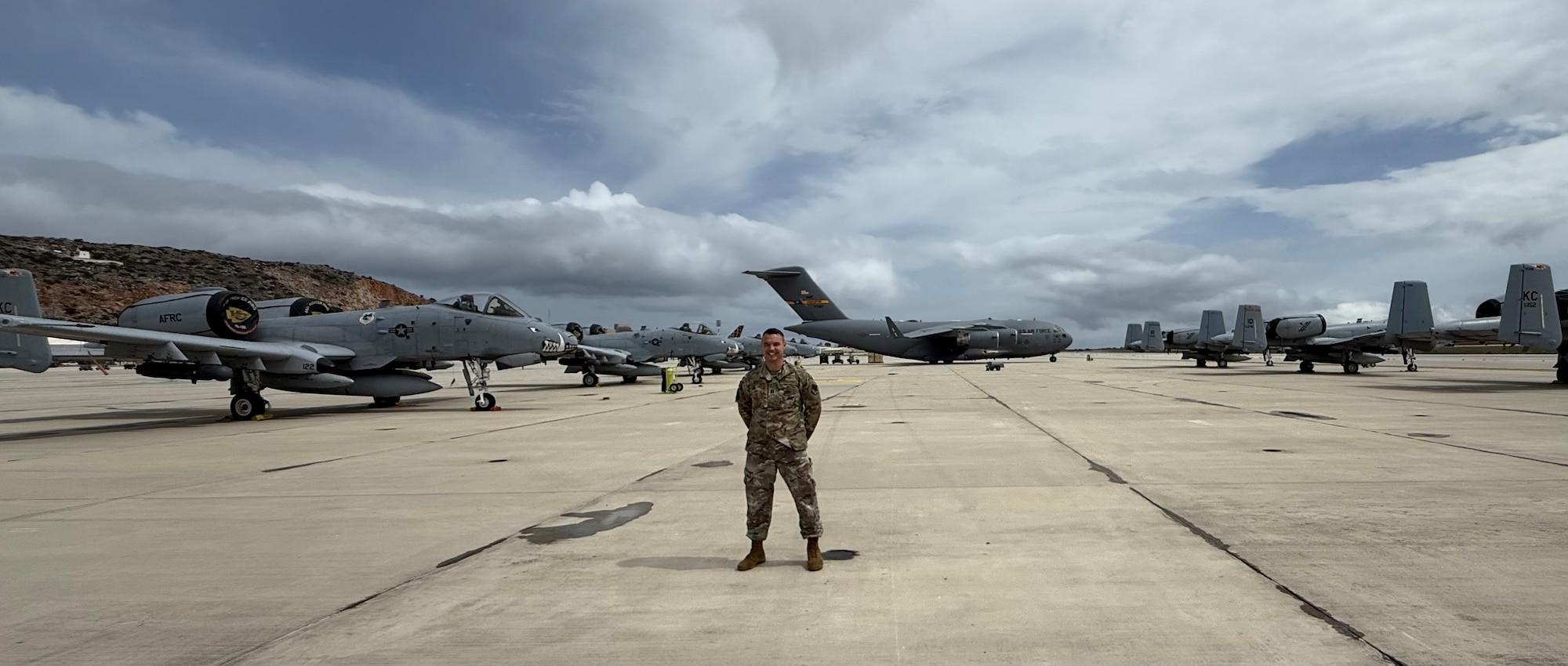 Capt. Samuel Burton, Detachment 1 95th Reconnaissance Squadron flight surgeon, from the 55th Operations Group, poses on the flightline at U.S. Naval Support Activity Souda Bay in Crete, Greece, April 1, 2025. While in Greece, Burton has filled his time through professional development, mentoring medical students, caring for patients, and participating in a medical conference. (Courtesy photo)
