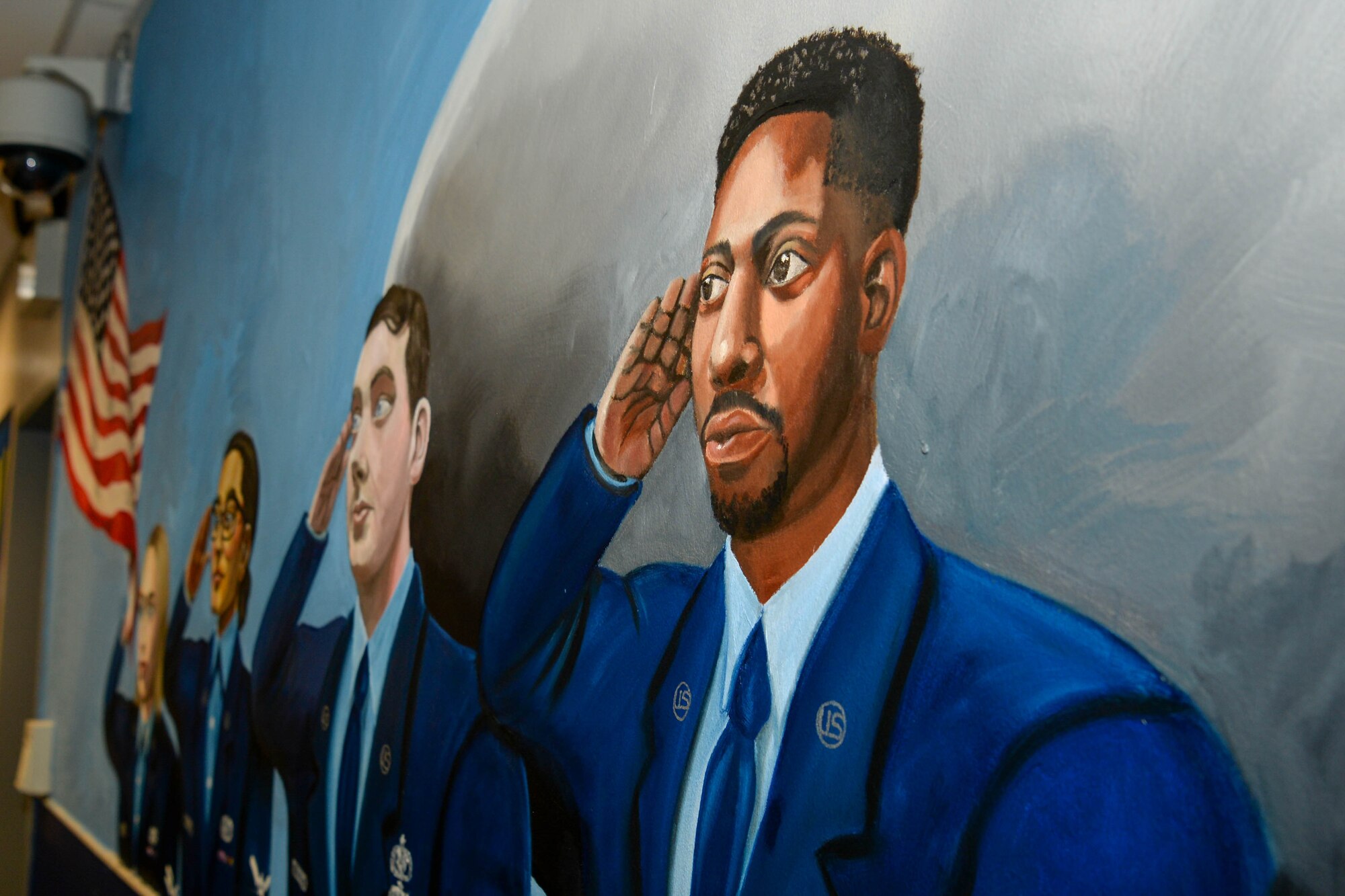 A mural is presented in a hallway.