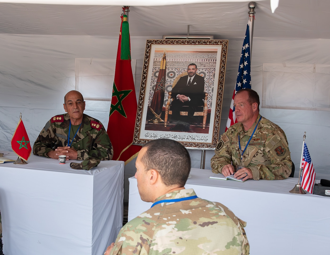 U.S. Air Force Col. Micah Smith, right, commander of 151st Medical Group, Utah Air National Guard, and a Royal Moroccan Armed Forces commander, discuss the daily operations of the Humanitarian Civic Assistance event in Anzi, Morocco, at African Lion 25.