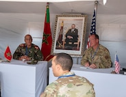 U.S. Air Force Col. Micah Smith, right, commander of 151st Medical Group, Utah Air National Guard, and a Royal Moroccan Armed Forces commander, discuss the daily operations of the Humanitarian Civic Assistance event in Anzi, Morocco, at African Lion 25.