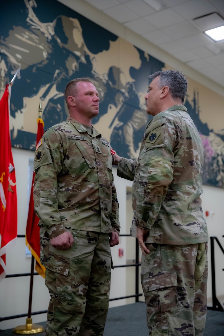 Maj. Gen. Thomas H. Mancino, adjutant general for Oklahoma, presents 1st Sgt. Matthew Klemann, Echo Company, 700th Brigade Support Battalion, with the Oklahoma Star of Valor award at the Armed Forces Reserves Center in Norman, Oklahoma, May 18, 2025. The medal is Oklahoma’s second-highest military award and honors Oklahoma National Guard members who perform heroic or valorous acts in non-combat situations. Klemann received the Star of Valor for his quick and courageous action in administering the Heimlich maneuver during a retirement ceremony in 2021. (Oklahoma National Guard photo by Spc. Cambrie Cannon)