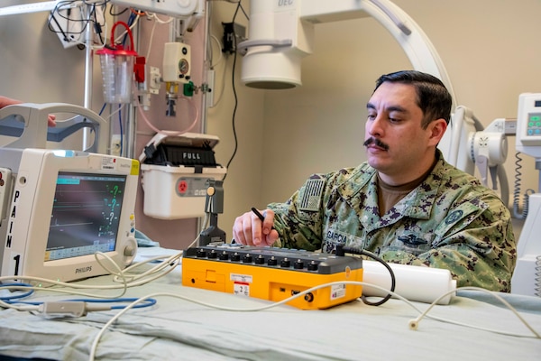 250219-O-NJ595-1093, Portsmouth, Virginia, (Jan. 29, 2025) Chief Eric Garcia, a biomedical equipment technician (BMET) with the Navy and Marine Corps Force Health Protection Command (NMCFHPC) prepares to check the diagnostics of a vital sign monitor during an annual equipment checkup for the hospital, Jan. 29, 2025, Naval Medical Center Portsmouth, Virginia. The annual equipment checks are conducted to ensure that all the equipment is working properly and calibrated to present accurate data. Biomedical specialists in the Navy focus on the application of medical, biological, and scientific principles to support naval operations and enhance the health of sailors, Marines, and their families. (U.S. Navy photo by Desmond Martin)