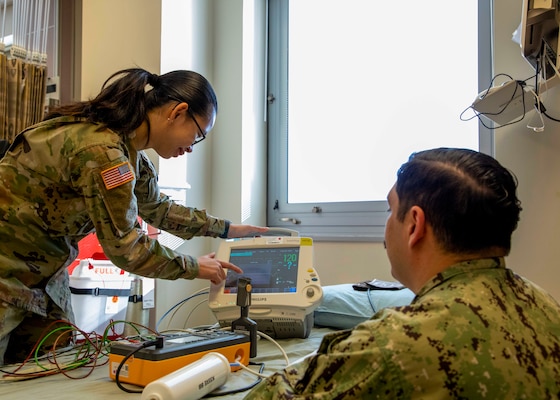 250219-O-NJ595-1094, Portsmouth, Virginia, (Jan. 29, 2025) Sgt. Ariane Nunley, a biomedical equipment technician (BMET) with the Lyster Army Health Clinic relays information from a vital sign monitor to Chief Eric Garcia, a BMET with the Navy and Marine Corps Force Health Protection Command (NMCFHPC) during a diagnostics test, Jan. 29, 2025, Naval Medical Center Portsmouth, Virginia. The diagnostic tests ensure that the equipment is functioning correctly and that it displays accurate data. The annual equipment checks are conducted to ensure that all the equipment is working properly and calibrated to present accurate data in support of warfighter readiness. (U.S. Navy photo by Desmond Martin)