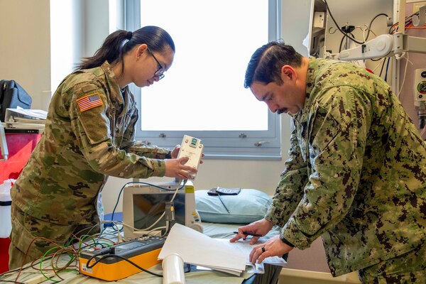 250219-O-NJ595-1095, Portsmouth, Virginia, (Jan. 29, 2025) Chief Eric Garcia, a biomedical equipment technician (BMET) with the Navy and Marine Corps Force Health Protection Command (NMCFHPC) verifies the serial number of a battery for a vitals sign monitor as Sgt. Ariane Nunley, a biomedical equipment technician (BMET) with the Lyster Army Health Clinic reads it to him, Jan. 29, 2025, Naval Medical Center Portsmouth, Virginia. The annual equipment checks are conducted to ensure that all the equipment is working properly and calibrated to present accurate data. During the gear check, service members would work together to ensure that all the information is correct and up to date. These efforts support also supports force health protection, medical readiness, and expeditionary capabilities. (U.S. Navy photo by Desmond Martin)