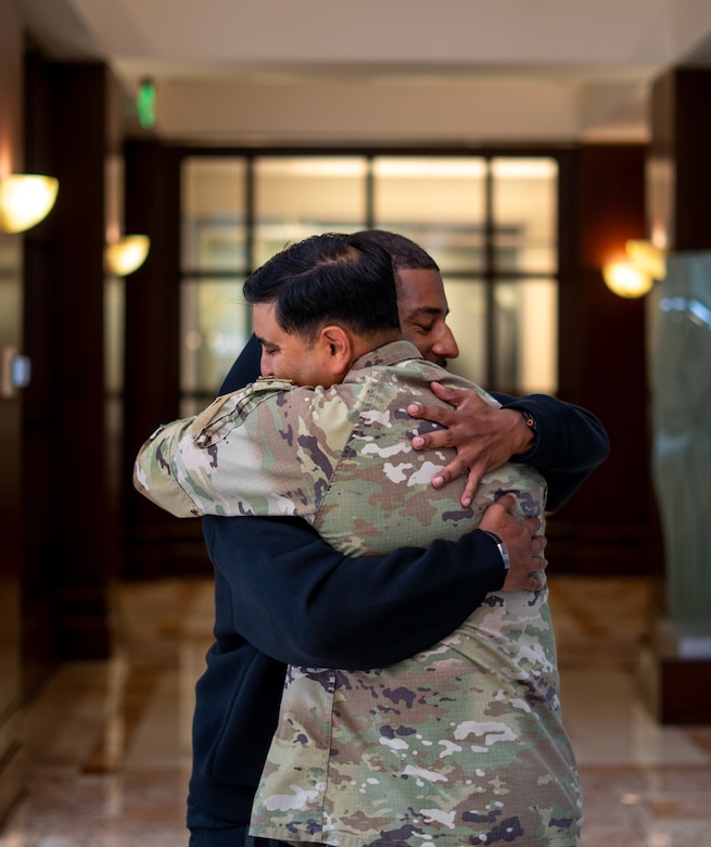 Col. Sonny Avichal, commander of the Emergency Field Office – Eaton, hugs Derek Russell Jr. after returning Russell’s late father’s police badge May 5 at the Southern California Wildfire Recovery Field Office building lobby in Pasadena, California. The badge was recovered from the debris of Russell’s home following the Eaton Fire in January.