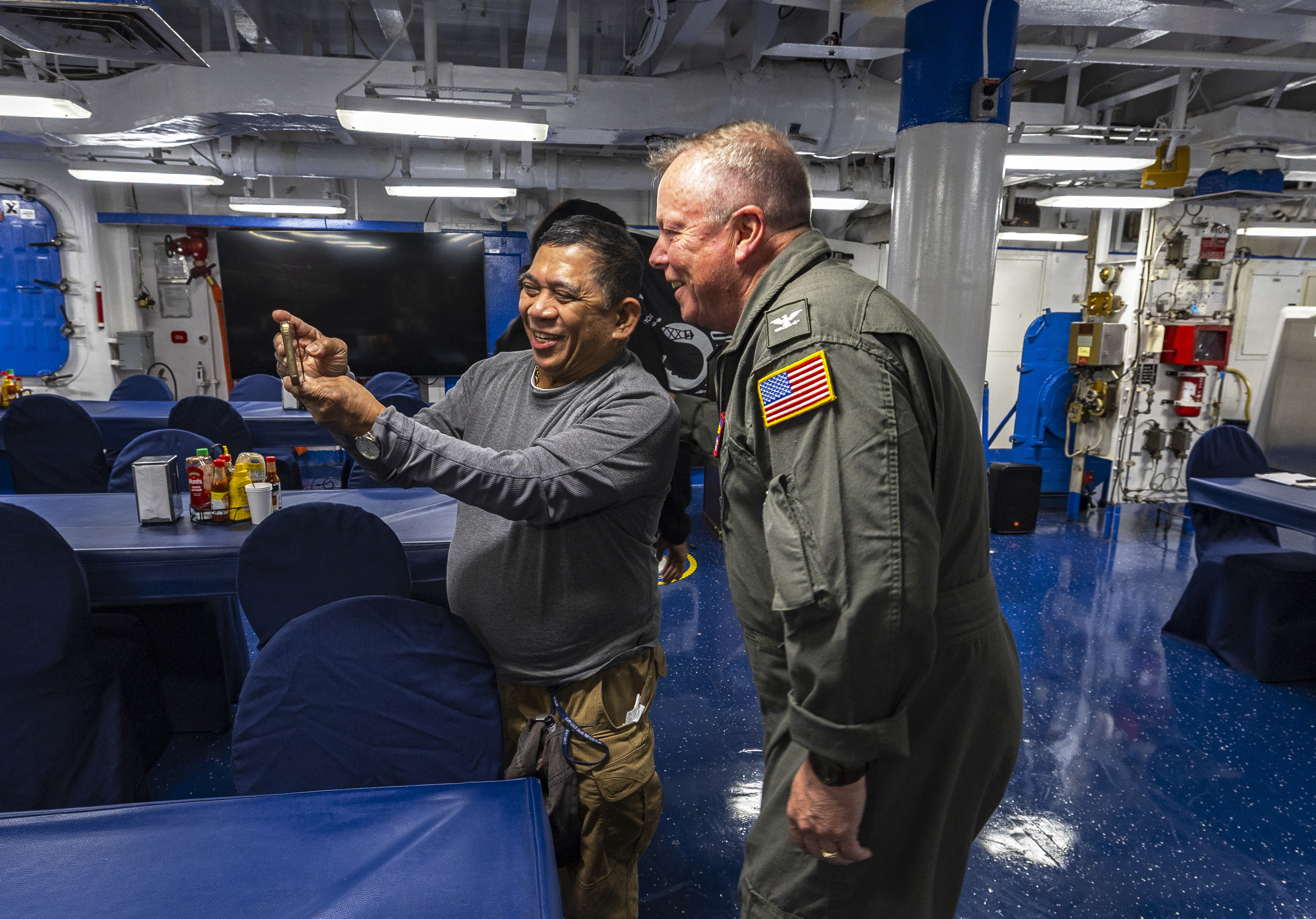 Capt. Todd B. Penrod, Commander, Task Force SIX THREE, Commander, Military Sealift Command Europe & Africa poses for a selfie with Supply Utilityman Alex Presto aboard the Blue Ridge-class command and control ship USS Mount Whitney (LCC 20) following an awards presentation on the ship's mess decks April 11. Penrod visited the ship to engage with the crew and conduct a ship check following the completion of regularly scheduled voyage repairs.