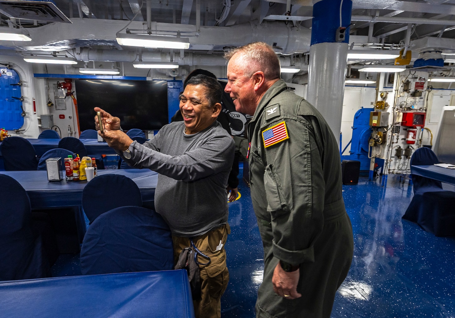 Capt. Todd B. Penrod, Commander, Task Force SIX THREE, Commander, Military Sealift Command Europe & Africa poses for a selfie with Supply Utilityman Alex Presto aboard the Blue Ridge-class command and control ship USS Mount Whitney (LCC 20) following an awards presentation on the ship's mess decks April 11. Penrod visited the ship to engage with the crew and conduct a ship check following the completion of regularly scheduled voyage repairs.