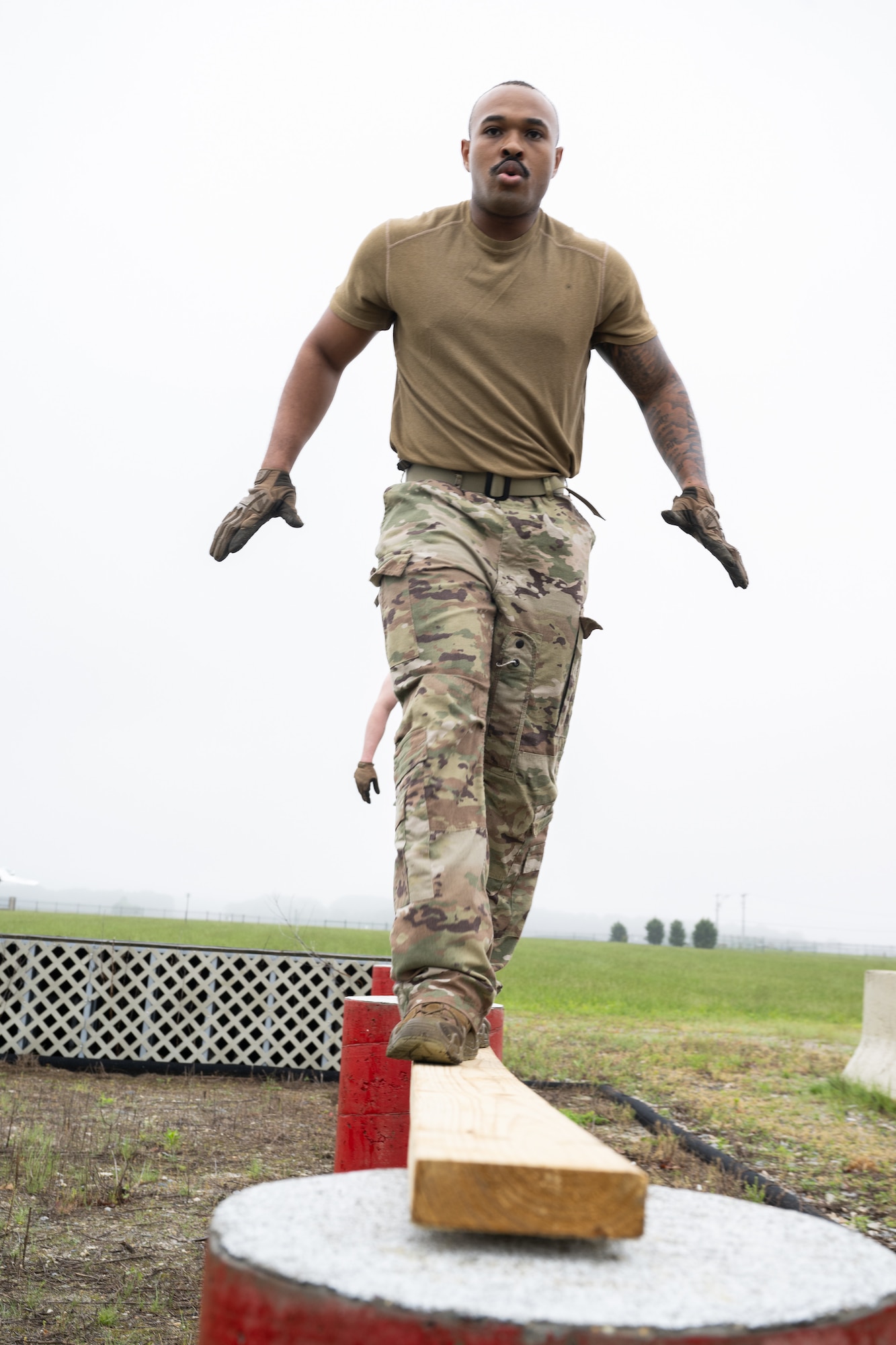 U.S. Air Force Staff Sgt. Jamarius Dandridge, 436th Security Forces Squadron Phoenix Raven team leader, maneuvers through an obstacle course during the Defender Challenge at Dover Air Force Base, Delaware, May 14, 2025. The event, which entailed teams of two performing various physical challenges, was part of Dover AFB’s 2025 Police Week observance. (U.S. Air Force photo by Mauricio Campino)