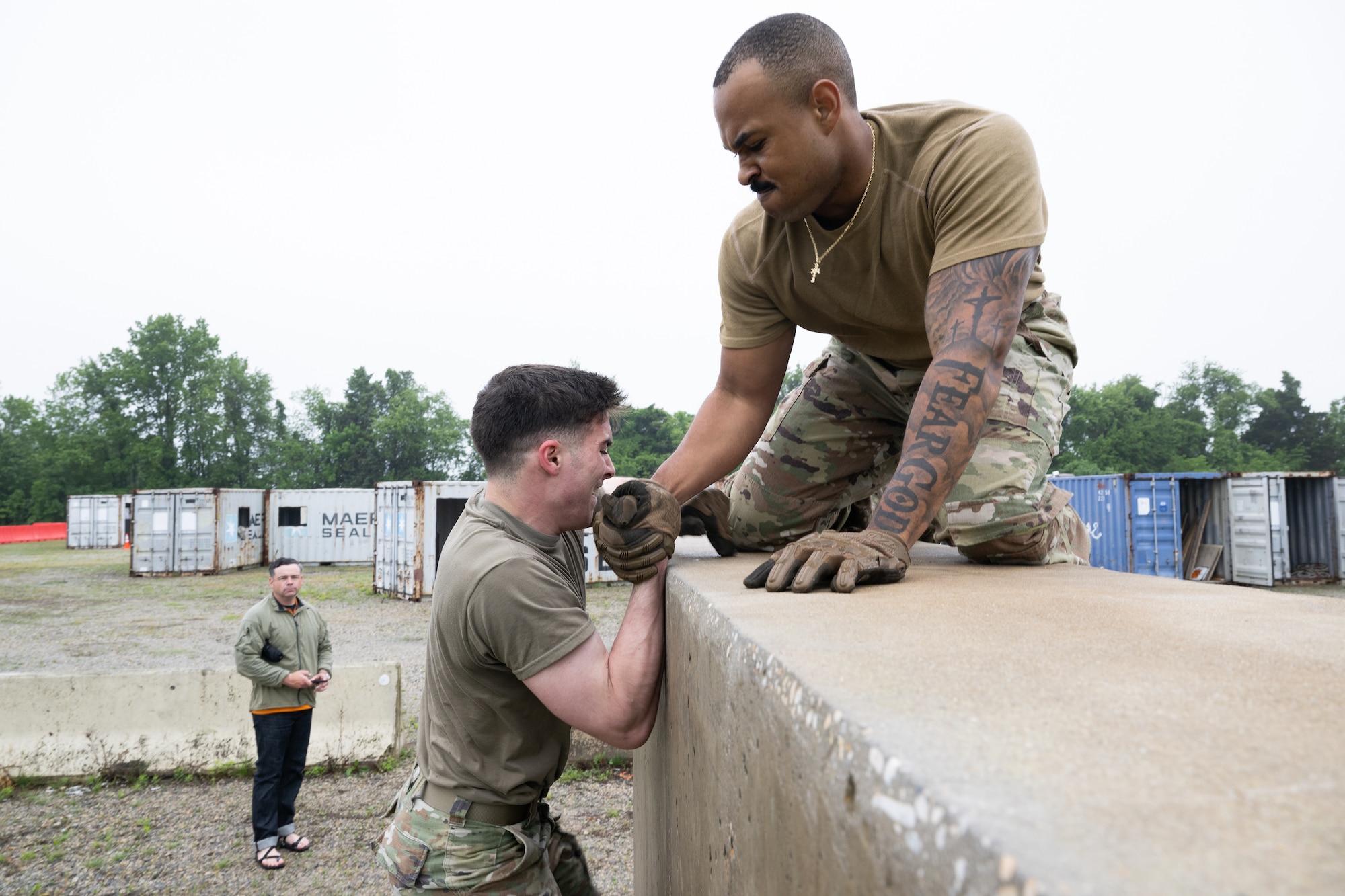 U.S. Air Force Staff Sgt. Jamarius Dandridge, right, 436th Security Forces Squadron Phoenix Raven team leader and Airman 1st Class Dylan Franklin, 436th SFS Phoenix Raven team member, maneuver through an obstacle course during the Defender Challenge at Dover Air Force Base, Delaware, May 14, 2025. The event, which entailed teams of two performing various physical challenges, was part of Dover AFB’s 2025 Police Week observance. (U.S. Air Force photo by Mauricio Campino)