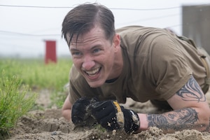 U.S. Air Force 2nd Lt. Samuel Kinney, 436th Aerial Port Squadron ramp operations officer in charge, maneuvers through an obstacle course during the Defender Challenge at Dover Air Force Base, Delaware, May 14, 2025. The event, which entailed teams of two performing various physical challenges, was part of Dover AFB’s 2025 Police Week observance. (U.S. Air Force photo by Mauricio Campino)