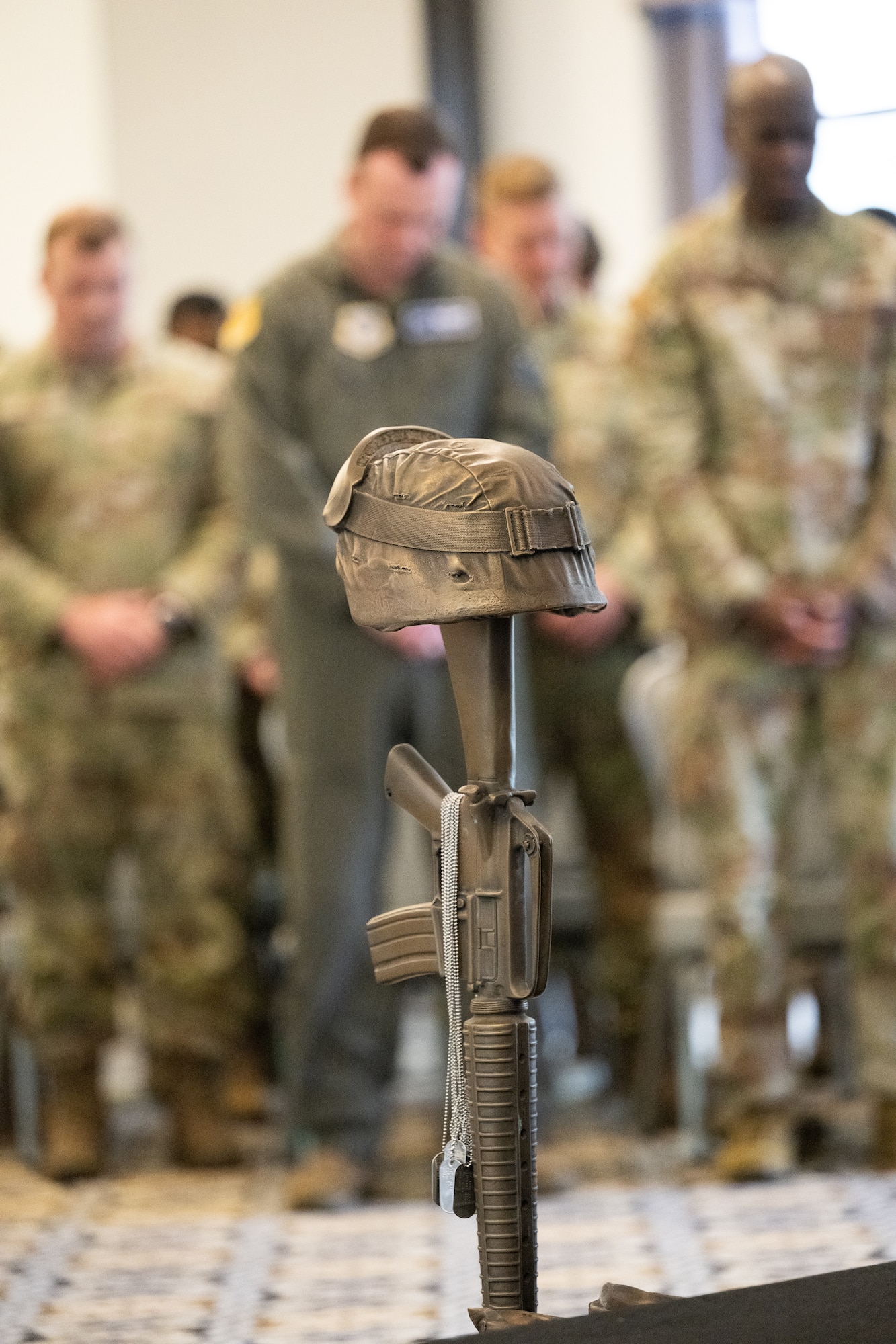 Members of Team Dover bow their heads during a memorial service at the conclusion of Police Week at Dover Air Force Base, Delaware, May 16, 2025. National Police Week was established in 1962 to honor law enforcement officers and to commemorate those who have lost their lives in the line of duty. (U.S. Air Force photo by Mauricio Campino)