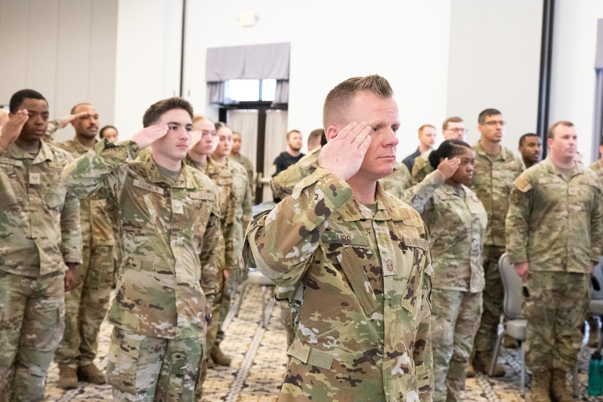 Members of the 436th Security Forces Squadron salute during a ceremony at a memorial service at the conclusion of Police Week at Dover Air Force Base, Delaware, May 16, 2025. National Police Week was established in 1962 to honor law enforcement officers and to commemorate those who have lost their lives in the line of duty. (U.S. Air Force photo by Mauricio Campino)