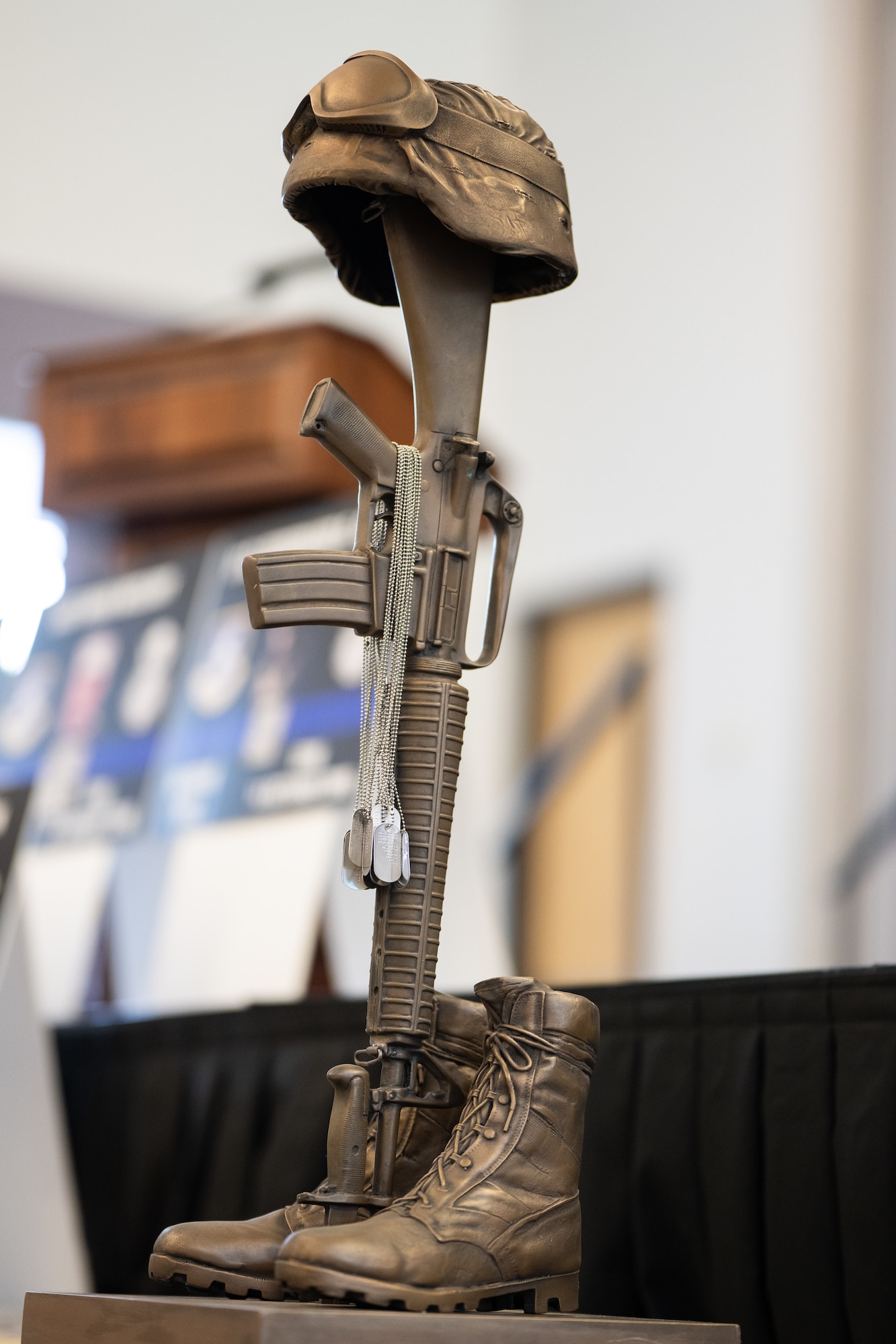 A military memorial statue with dog tags representing fallen security forces members is displayed at a memorial service at the conclusion of Police Week at Dover Air Force Base, Delaware, May 16, 2025. National Police Week was established in 1962 to honor law enforcement officers and to commemorate those who have lost their lives in the line of duty. (U.S. Air Force photo by Mauricio Campino)