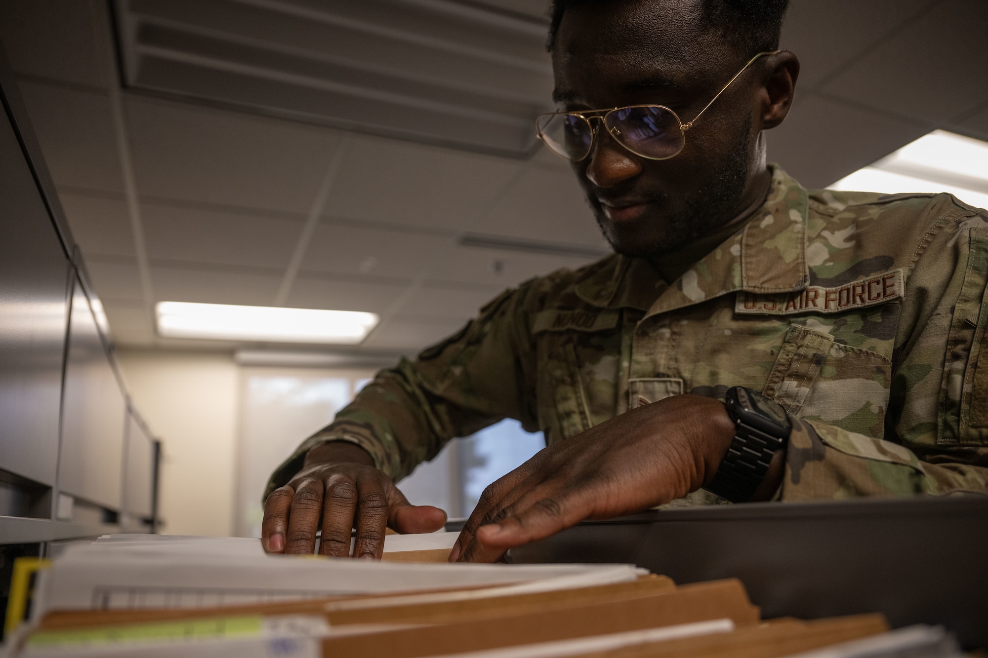 U.S. Air Force Senior Airman Kobina Nunoo, 436th Comptroller Squadron financial operation technician, searches a file drawer at Dover Air Force Base, Delaware, May 1, 2025. The 436th CPTS is responsible for funds accounting and budget planning, programming, execution and analysis. The squadron also supports Air Mobility Command worldwide mobility requirements through funds disbursement, travel order processing and deployment of personnel. (U.S. Air Force photo by Airman 1st Class Liberty Matthews)