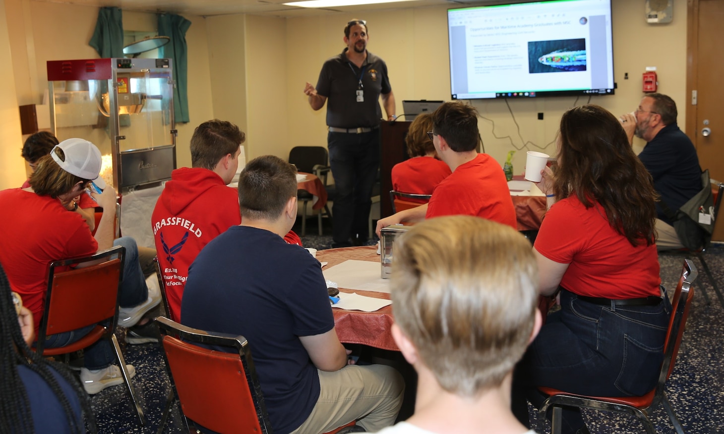 Twenty-three students of the Governor’s Science, Technology, Engineering, and Mathematics (STEM) Academy in Chesapeake, Va., visited Military Sealift Command’s (MSC) USNS Joshua Humphreys (T-AO 188) on April 24, 2025.  Pictured above is MSC’ s N751 Type Desk T-AO 205 Class Supervisor Benjamin R. Miner who presented a brief to students on MSC’s daily operations and shore-based careers opportunities such as Naval Architects, Mariner Engineers, Program Managers, Logistics Managers, and Acquisition and Contract Officers.