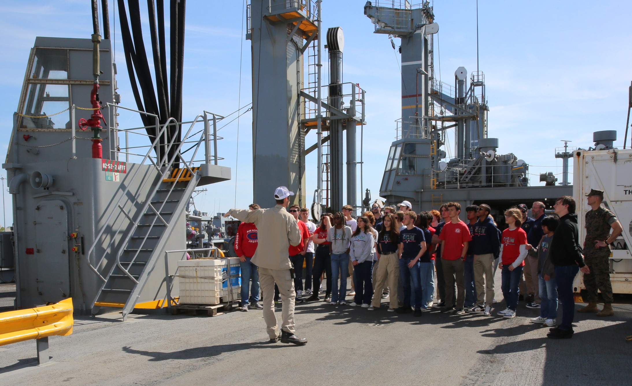 Twenty-three students of the Governor’s Science, Technology, Engineering, and Mathematics (STEM) Academy in Chesapeake, Va., visited Military Sealift Command’s (MSC) USNS Joshua Humphreys (T-AO 188) on April 24, 2025. Pictured center is Chief Mate Miles Faver, explaining the two types of replenishment services Joshua Humphreys provides the warfighting ships at sea.