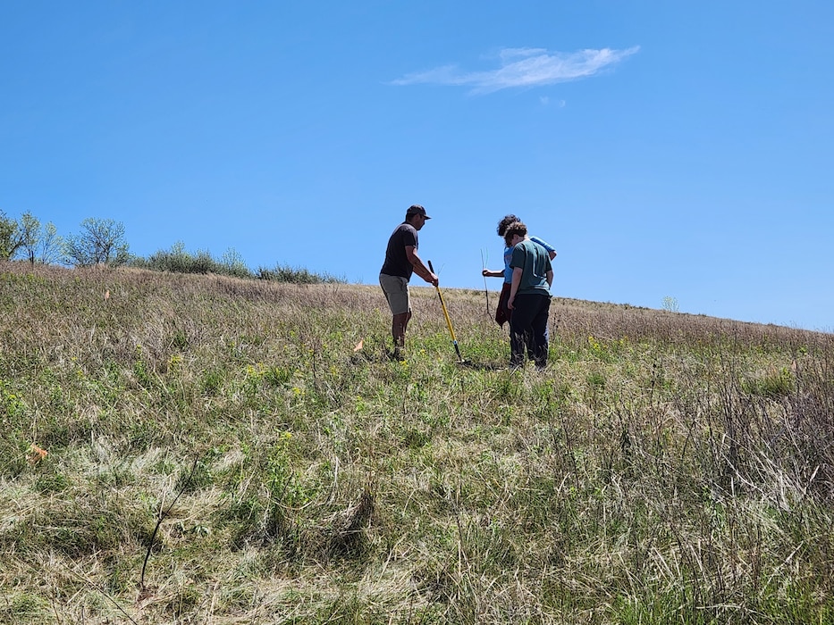 A WOZU team member provides guidance to students planting native trees along the Cannonball River, N.D., during a joint project with the U.S. Army Corps of Engineers, Omaha District’s Oahe Project, May 12, 2025.