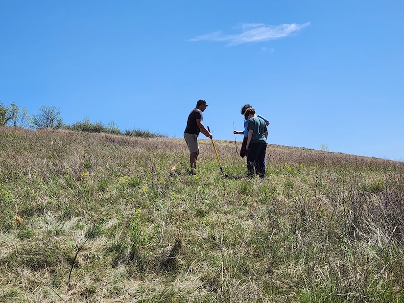 A WOZU team member provides guidance to students planting native trees along the Cannonball River, N.D., during a joint project with the U.S. Army Corps of Engineers, Omaha District’s Oahe Project, May 12, 2025.