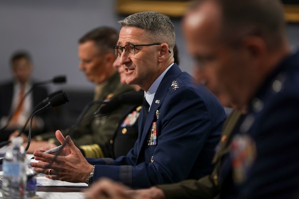 Gen. Steve Nordhaus speaks to off-camera committee members while sitting at a table in between the reserve component chiefs.