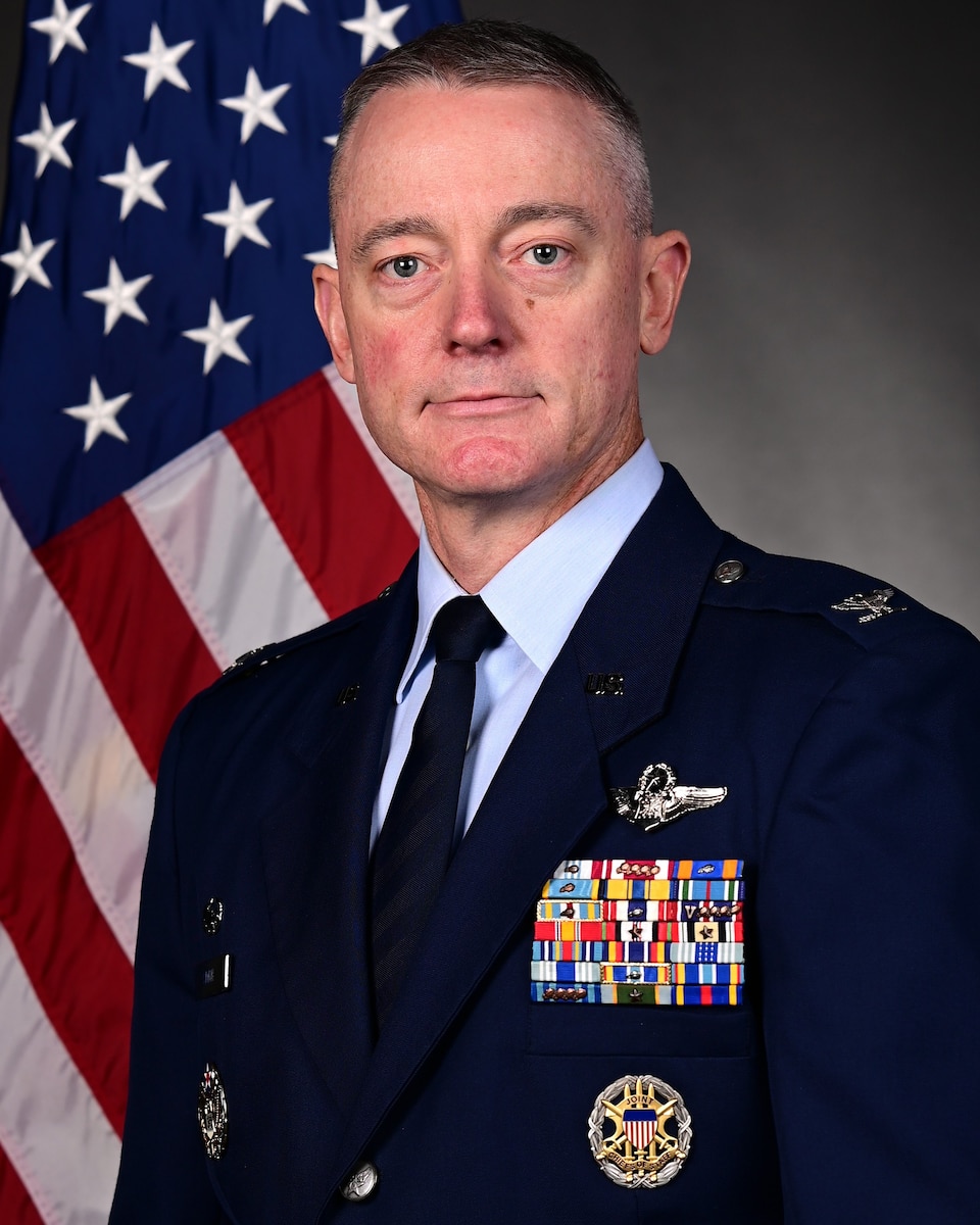 Man in uniform poses for photo
