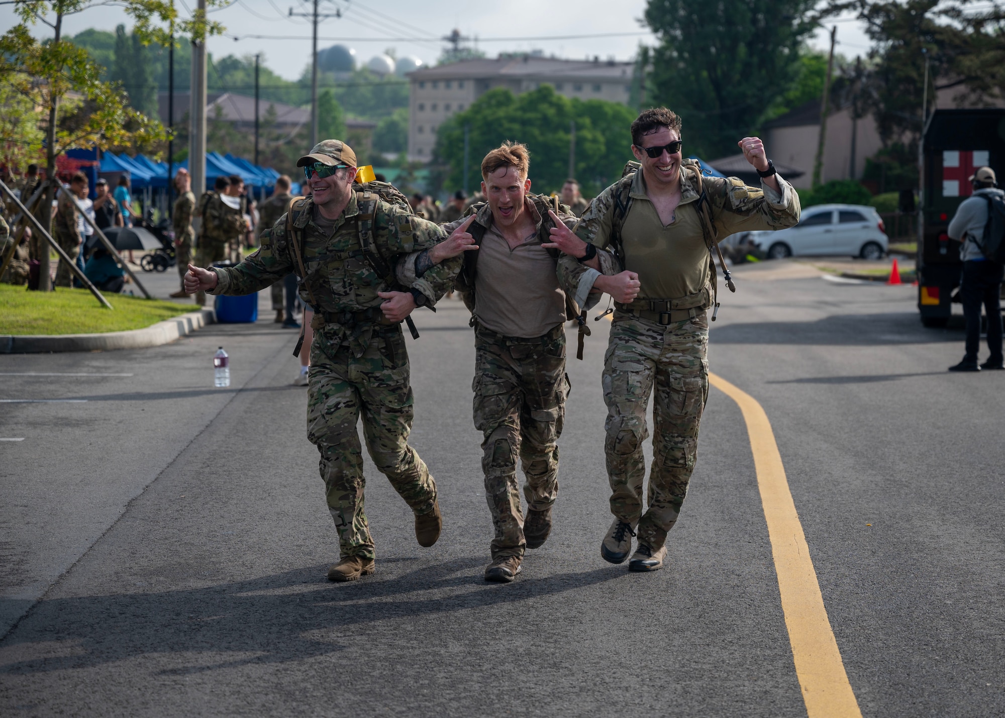 Participants of the Four Chaplain Memorial Run and Ruck dash to the finish line at Osan Air Base, Republic of Korea, May 17, 2025. The NFM was first held in 1915 to test the physical stamina of soldiers in the Norwegian Army and prepare them for long marches in harsh conditions. (U.S. Air Force photo by Senior Airman Sarah Williams)