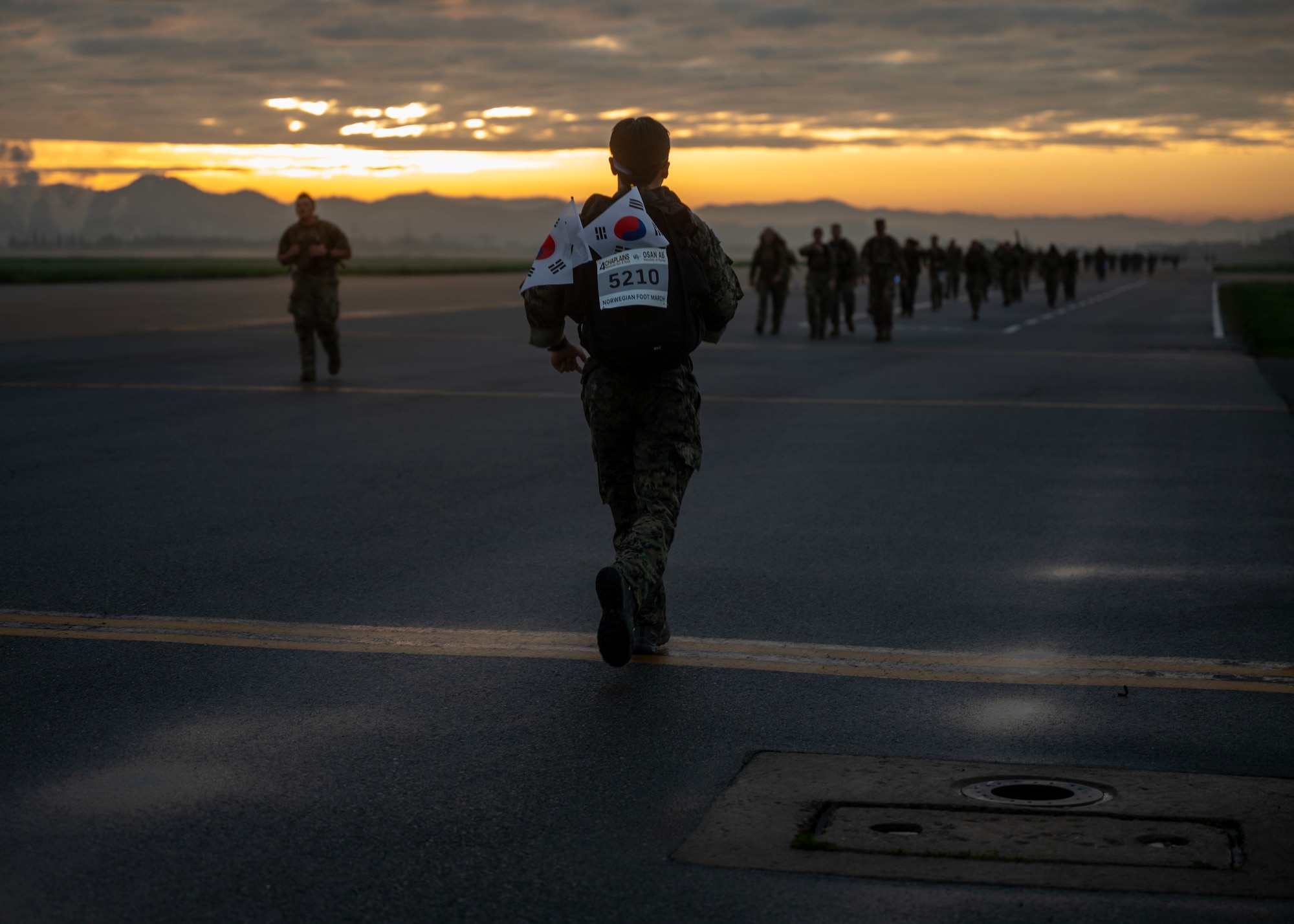 A participant of the Four Chaplain Memorial Run and Ruck completes his second lap during the Norwegian Foot March at Osan Air Base, Republic of Korea, May 17, 2025. More than 930 participants from four nations gathered to honor the sacrifice of the four chaplains and celebrate the spirit of unity, endurance and resilience. (U.S. Air Force photo by Senior Airman Sarah Williams)
