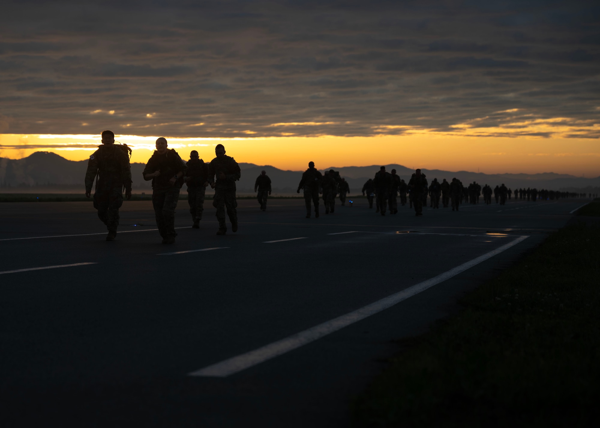 Participants of the Four Chaplain Memorial Run and Ruck trek through the Norwegian Foot March course at Osan Air Base, Republic of Korea, May 17, 2025. The NFM was first held in 1915 to test the physical stamina of soldiers in the Norwegian Army and prepare them for long marches in harsh conditions. (U.S. Air Force photo by Senior Airman Sarah Williams)