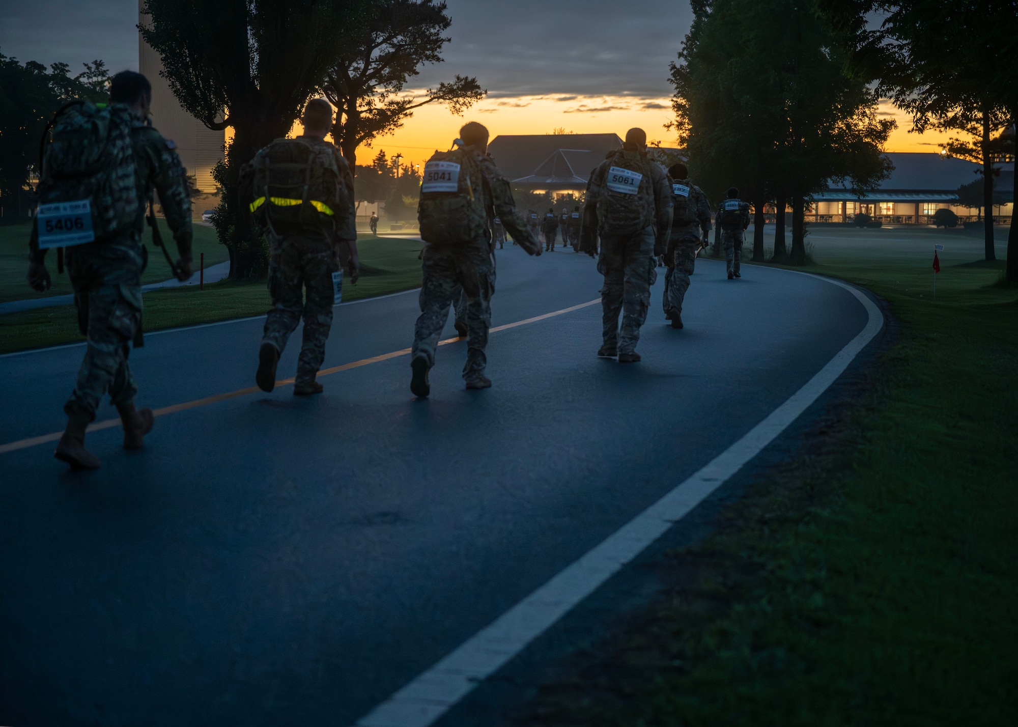 Participants walk the Norwegian Foot March during the Four Chaplain Memorial Run and Ruck at Osan Air Base, Republic of Korea, May 17, 2025. Those who completed the march earned the Norwegian Foot March badge, which can be worn on military uniforms as a symbol of discipline, strength and endurance. (U.S. Air Force photo by Senior Airman Sarah Williams)