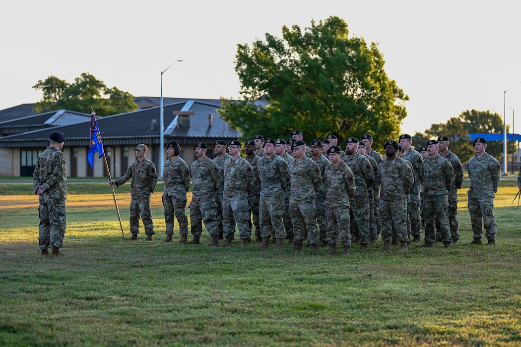 Airmen from the 97th Security Forces Squadron stand at parade rest, during the 2025 National Police Week opening ceremony at Altus Air Force Base, Oklahoma, May 11, 2025. Police Week was established in 1962 by former President John F. Kennedy. (U.S. Air Force photo by Airman 1st Class Lauren Torres)